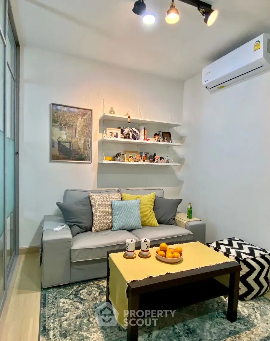 Cozy living room with modern decor and air conditioning, perfect for relaxation.