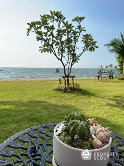 Stunning beachfront garden view with lush greenery and decorative table setting.