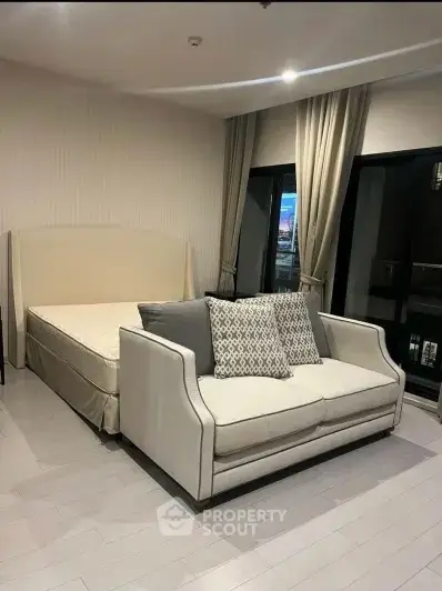 Modern bedroom with elegant sofa and large windows for natural light