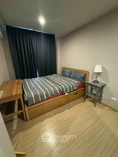Cozy bedroom with modern furnishings and natural light, perfect for relaxation and comfort.