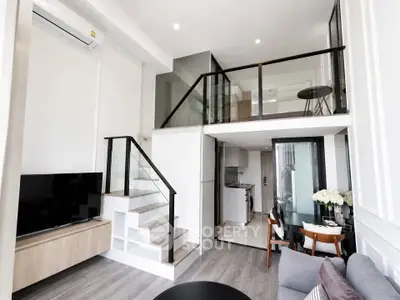Modern loft apartment with mezzanine, stylish living area, and sleek kitchen design.