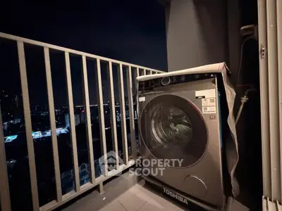 Modern balcony with city view and washing machine, perfect for urban living.