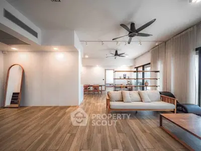 Spacious modern living room with wooden flooring and stylish furniture