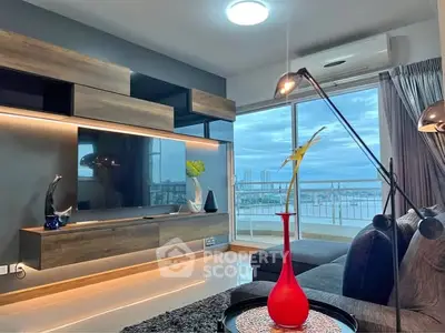 Modern living room with stylish decor and stunning city view through large windows.