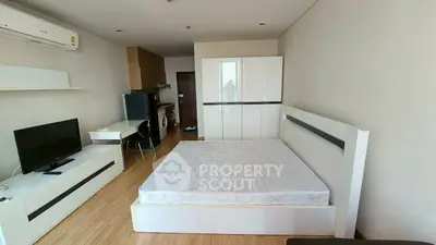 Modern studio apartment with sleek furniture and integrated appliances