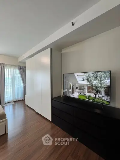 Modern bedroom with sleek furniture and large window for natural light