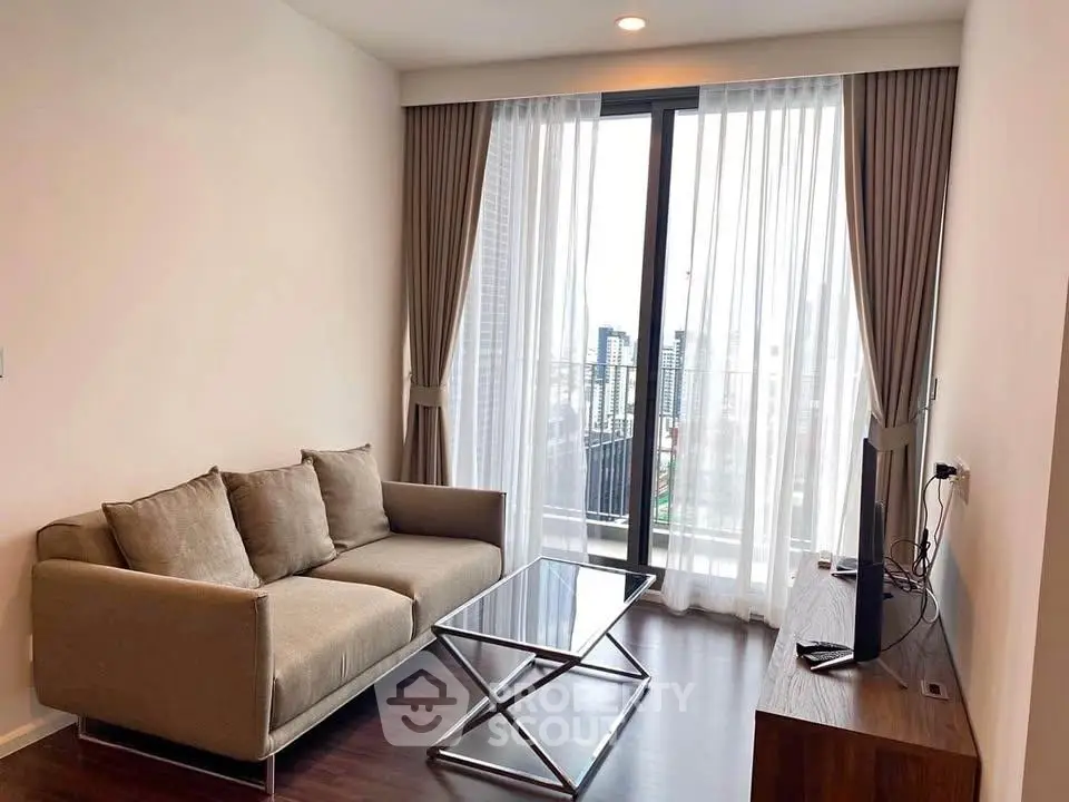 Modern living room with city view, featuring a sleek sofa and glass coffee table, perfect for urban living.
