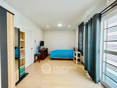 Spacious bedroom with modern decor and natural light