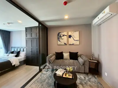 Modern living room with stylish decor and adjacent bedroom view