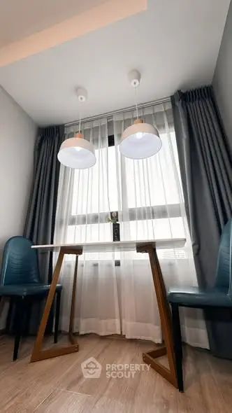 Cozy dining nook with modern lighting and elegant curtains