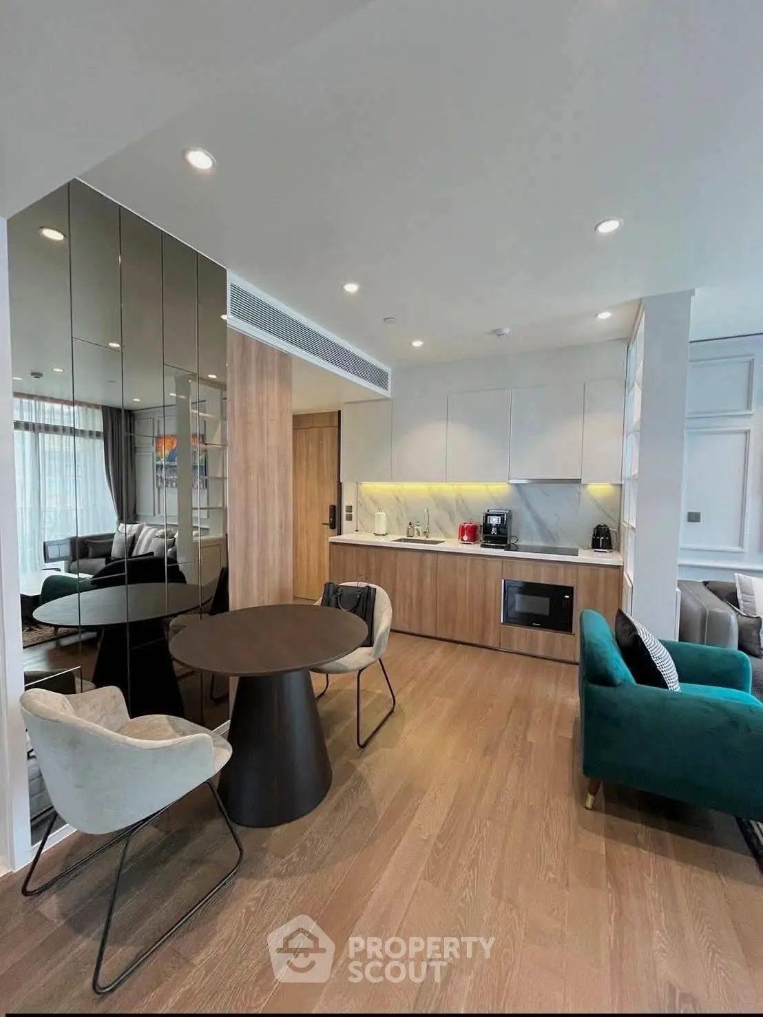 Modern open-plan living room with stylish kitchen and elegant furnishings