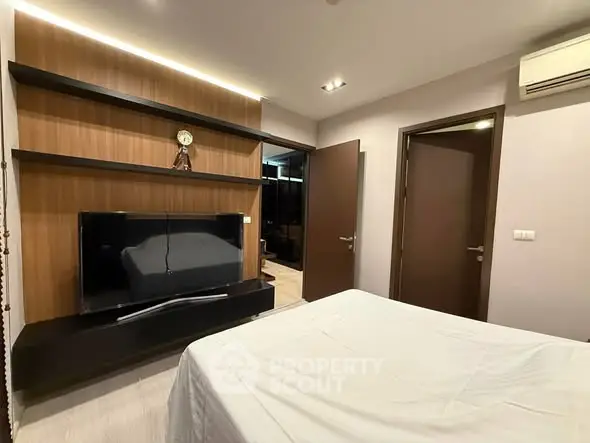 Modern bedroom with sleek TV unit and stylish decor