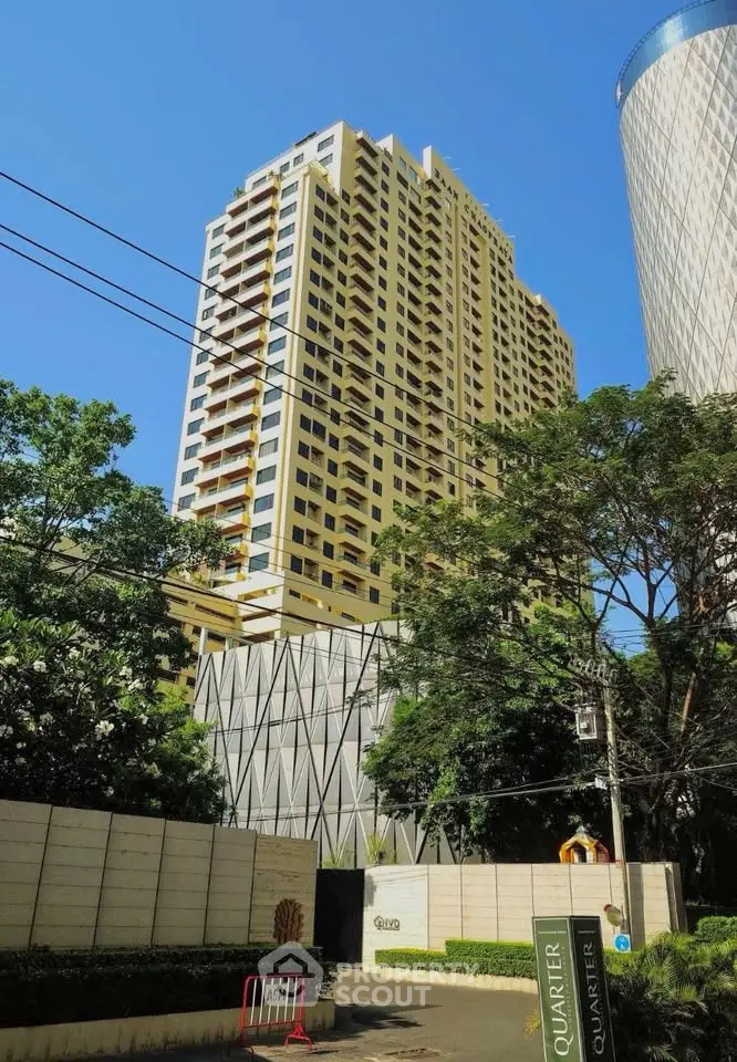 Stunning high-rise building with modern architecture and lush greenery, perfect for urban living.