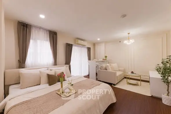 Luxurious bedroom with elegant decor and cozy seating area