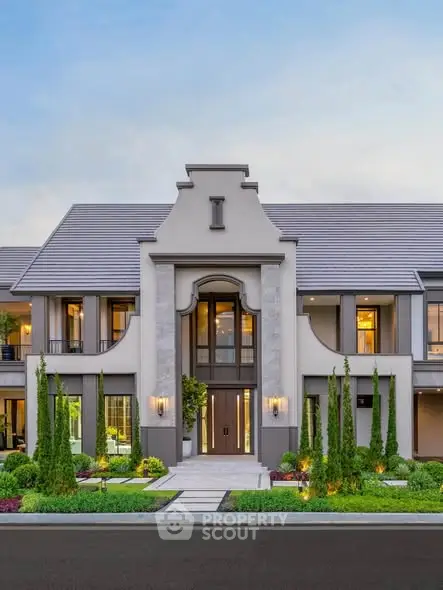 Stunning modern mansion exterior with lush landscaping and elegant architectural design.