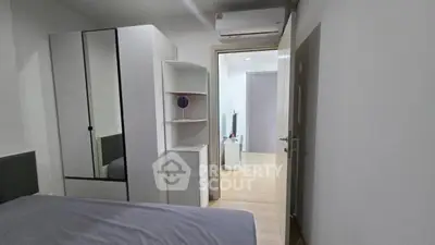 Modern bedroom with sleek furniture and air conditioning in a stylish apartment.
