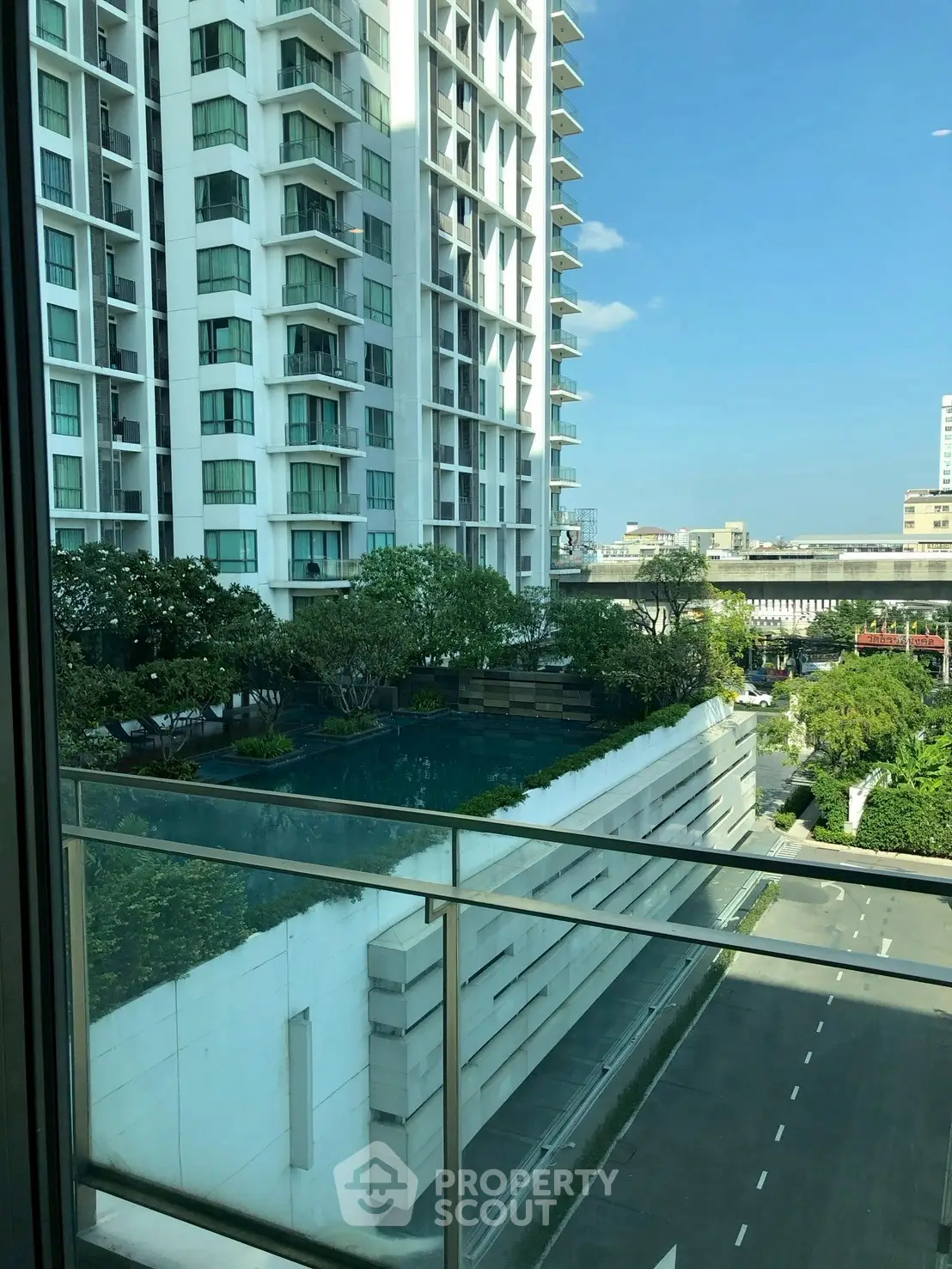 Modern high-rise building with pool view from balcony