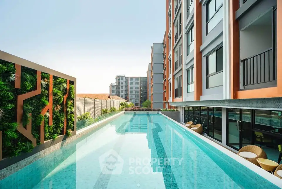 Luxurious modern apartment complex with stunning rooftop pool and lush greenery.