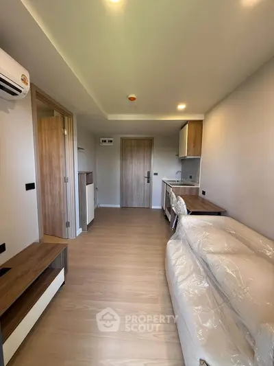 Modern apartment interior with compact kitchen and cozy living area