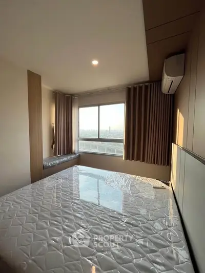 Bright bedroom with large window and city view, featuring modern design and air conditioning.