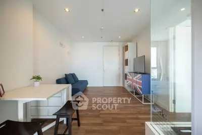 Modern living room with stylish decor and hardwood floors in a bright apartment.