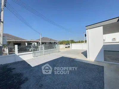 Spacious modern driveway with gated entrance in a suburban neighborhood