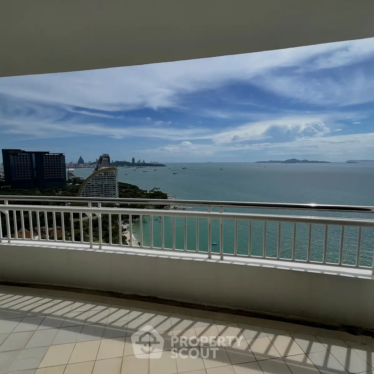 Stunning ocean view from a spacious balcony in a high-rise apartment, perfect for luxury living.
