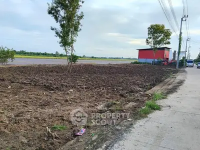 Vacant land plot with potential for development, featuring open space and nearby infrastructure.