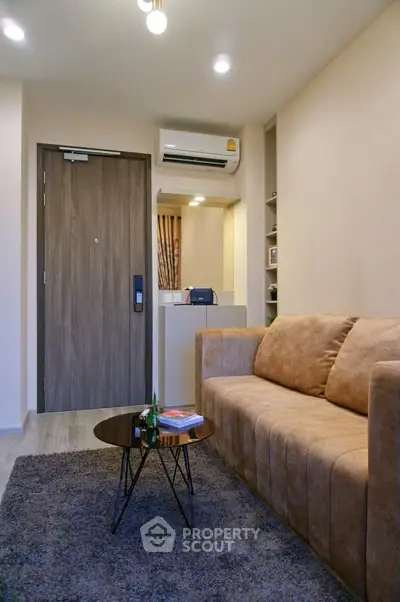 Modern living room with cozy sofa and stylish decor in a contemporary apartment.