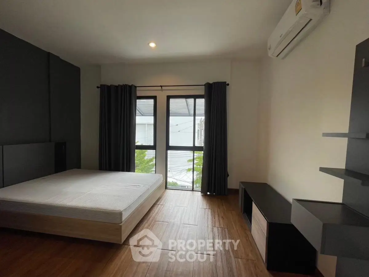 Spacious bedroom with modern design and large window for natural light