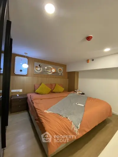 Cozy modern bedroom with stylish decor and warm lighting, perfect for relaxation and comfort.