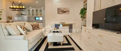Luxurious living room with elegant decor and modern kitchen in open layout