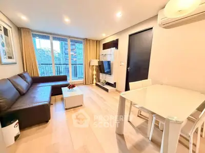 Modern living room with sleek furniture and large windows offering natural light.