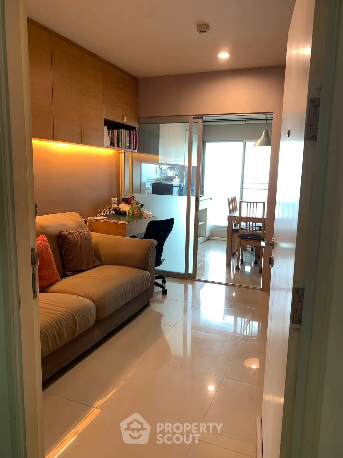 Cozy living room with modern decor and open dining area, perfect for urban living.