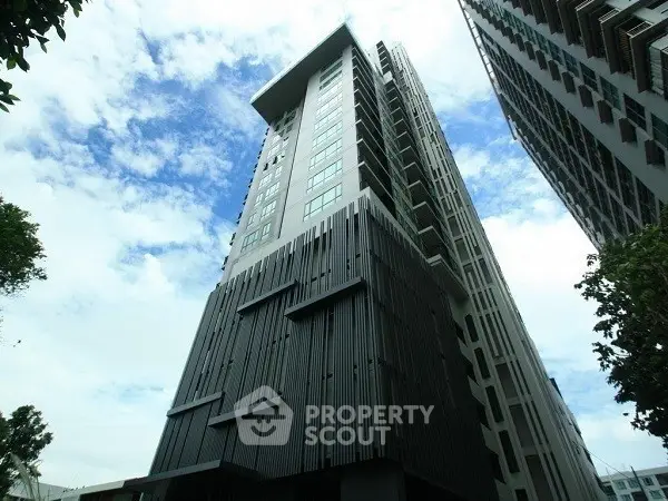 Stunning modern high-rise building with sleek architectural design against a clear blue sky.