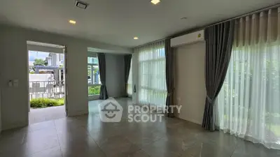 Spacious modern living room with large windows and garden view
