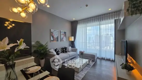 Modern living room with elegant decor and city view through large windows.