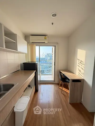 Modern kitchen with sleek design and city view from balcony
