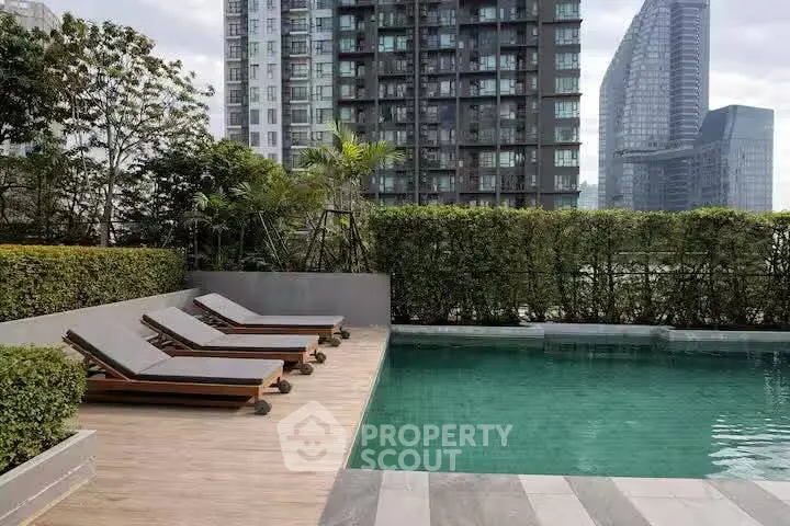 Luxurious urban poolside with modern high-rise backdrop and lush greenery
