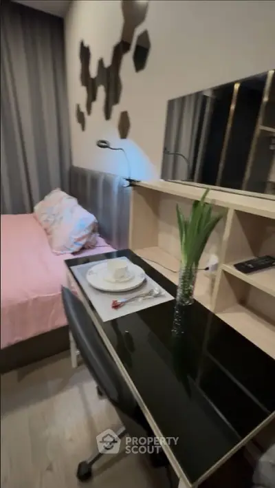 Modern bedroom with stylish decor and workspace, featuring a comfortable bed and sleek desk.