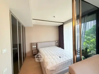 Spacious bedroom with large windows and garden view in modern apartment