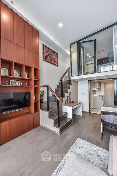 Modern duplex living room with wooden accents and open staircase