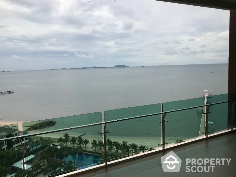 Stunning ocean view from spacious balcony in luxury beachfront property.