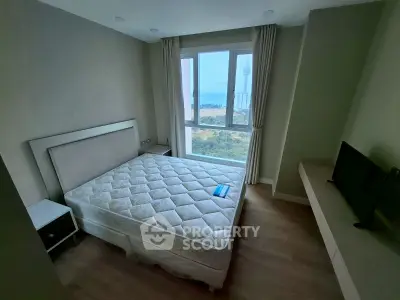 Cozy bedroom with a stunning view, featuring a comfortable bed and modern decor.
