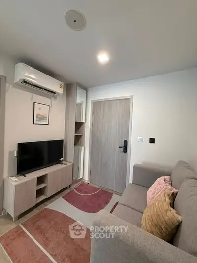 Cozy modern living room with stylish decor and air conditioning