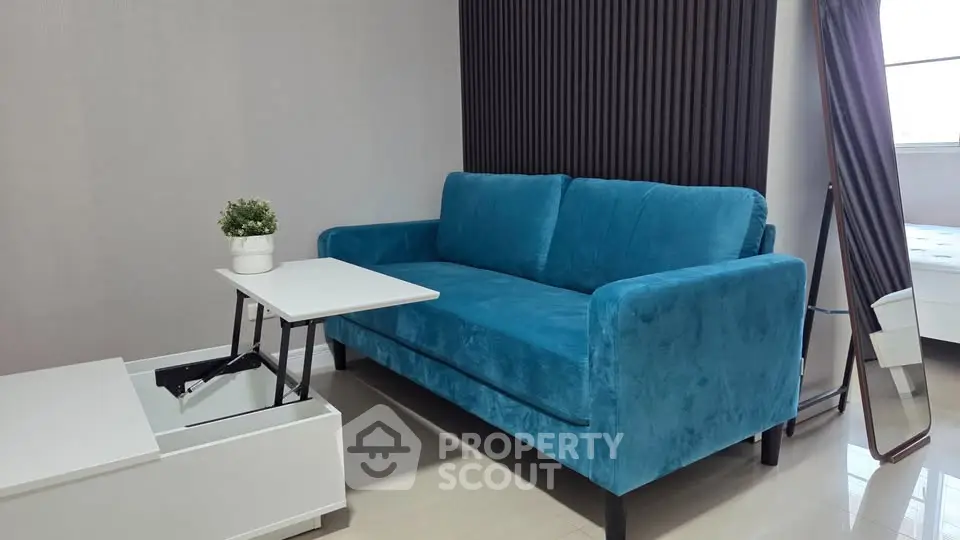 Modern living room with blue sofa and sleek furniture