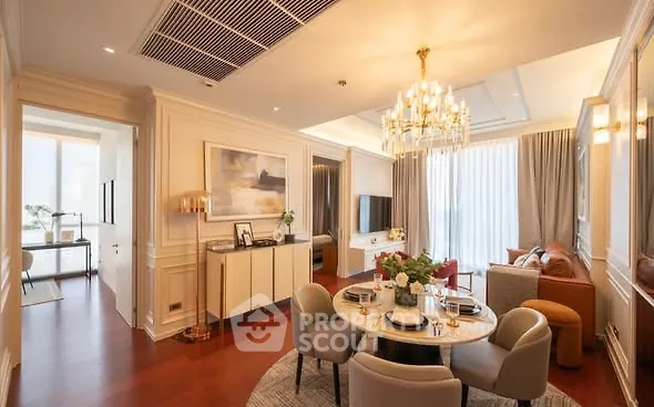 Luxurious living room with elegant chandelier and stylish decor in modern apartment.