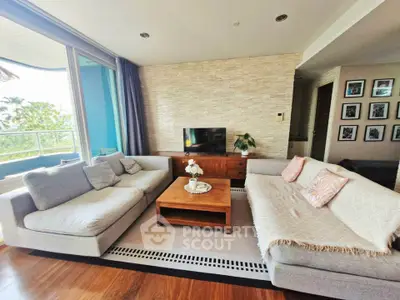 Spacious living room with modern decor and large windows offering a scenic view.
