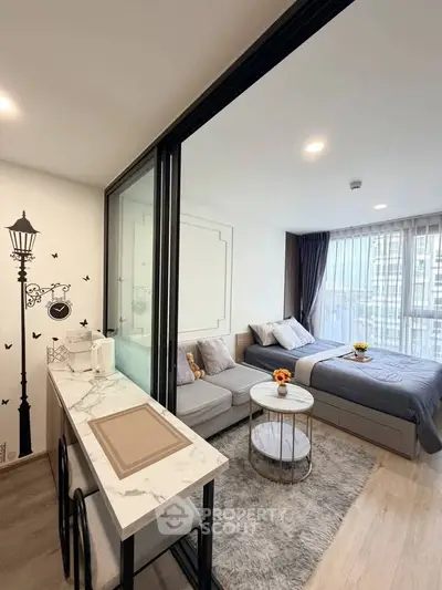 Modern studio apartment with stylish decor and cozy sleeping area