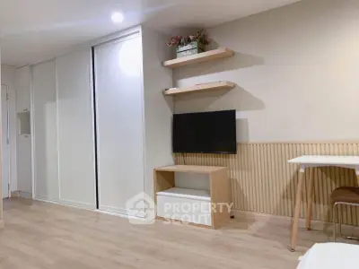 Modern living room with sleek storage and mounted TV, perfect for urban living.